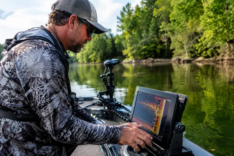 Bass tackle and sonar unit on the deck of a fishing boat