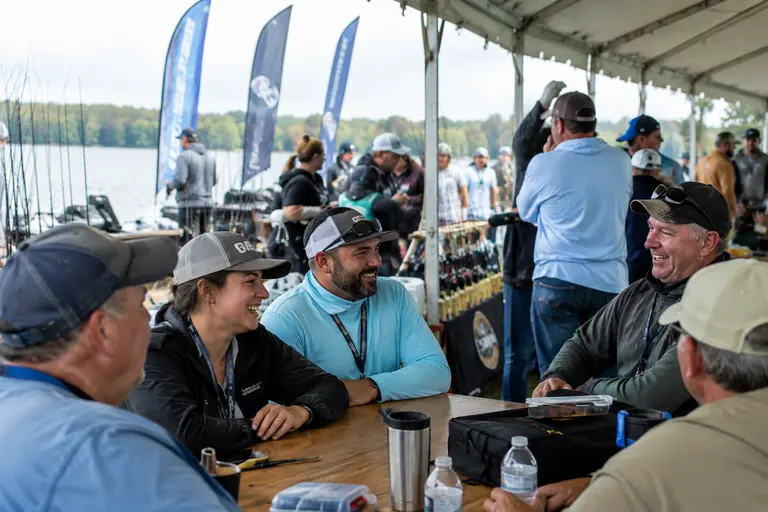 Families and anglers gathered near a reservoir weigh-in area